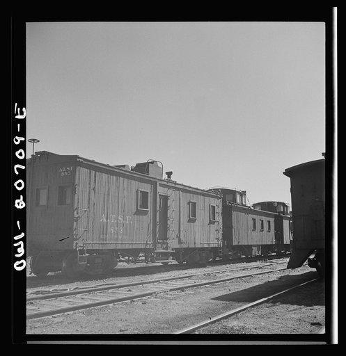 Untitled photo, possibly related to: Vaughn, New Mexico. A caboose on the Atchison, Topeka and Santa Fe Railroad yard converted from an old box car
