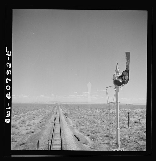 Untitled photo, possibly related to: Willard, New Mexico. Flagman walks back to flag any oncoming trains his train stops for water between Vaughn and Belen, New Mexico on the Atchison, Topeka and Santa Fe Railroad