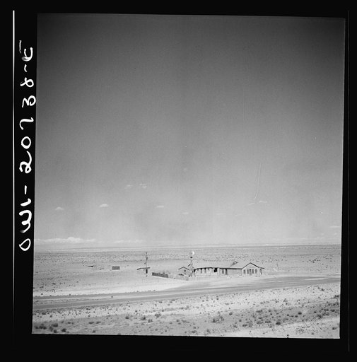 Untitled photo, possibly related to: Willard, New Mexico. Passing a filling station in the desert country along the Atchison, Topeka and Santa Fe Railroad between Vaughn and Belen, New Mexico