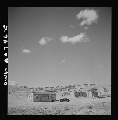 Mountainair, New Mexico. Going down the mountain on the Atchison, Topeka and Santa Fe Railroad, between Vaughn and Belen, New Mexico. Filling station and adobe houses on roadside