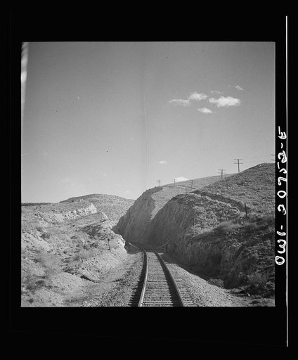 Untitled photo, possibly related to: Coming out of the mountains on the Atchison, Topeka and Santa Fe Railroad between Vaughn and Belen, New Mexico into the Rio Grande River Valley. In the distance is a quarry on the mountainside where the railroad gets its rock for ballast