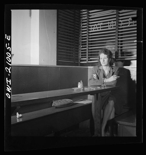 Washington, D.C. Girl sitting alone in the Sea Grill, a bar and restaurant waiting for a pickup. "I come in here pretty often, sometimes alone, mostly with another girl, we drink beer, and talk, and of course we keep our eyes open--you'd be surprised at how often nice, lonesome soldiers ask Sue, the