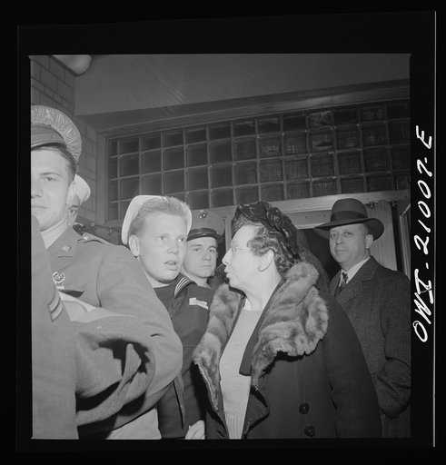 Washington, D.C. Woman standing in line with her son until he leaves on the bus at the Greyhound bus depot