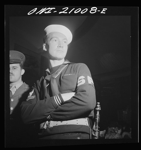 Washington, D.C. Member of the Shore Patrol who helps get servicemen lined up and in order while waiting for special buses to leave the Greyhound bus terminal on Sunday evenings