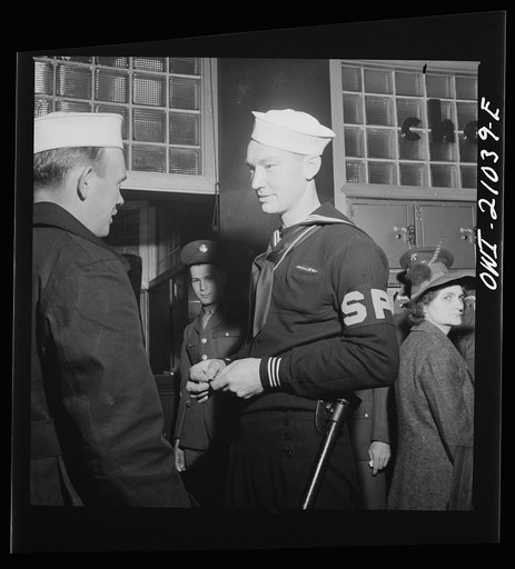 Untitled photo, possibly related to: Washington, D.C. Member of the Shore Patrol who helps get servicemen lined up and in order while waiting for special buses to leave the Greyhound bus terminal on Sunday evenings