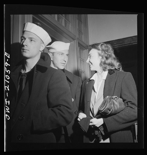 Washington, D.C. Part of the line waiting to board one of the special busses for servicemen leaving the Greyhound terminal on Sunday nights. Girls stand in line with soldiers and sailors keeping them company until they leave