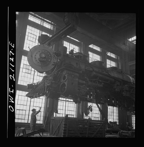 Albuquerque, New Mexico. Lifting an engine to be carried to another part of the Atchison, Topeka and Santa Fe Railroad shops for wheeling