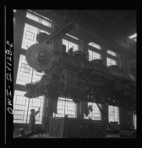 Untitled photo, possibly related to: Albuquerque, New Mexico. Lifting an engine to be carried to another part of the Atchison, Topeka and Santa Fe Railroad shops for wheeling