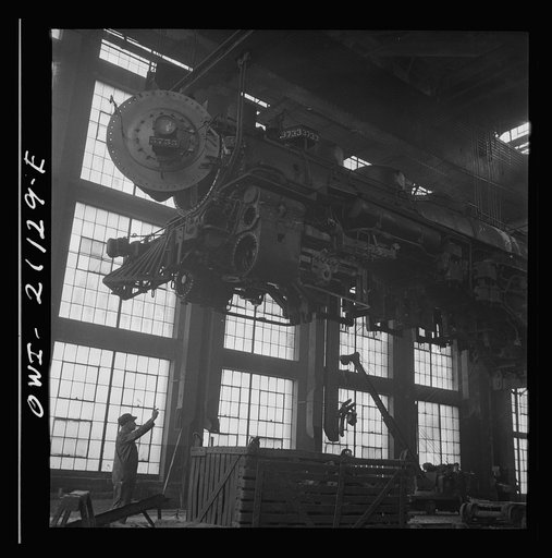 Untitled photo, possibly related to: Albuquerque, New Mexico. Lifting an engine to be carried to another part of the Atchison, Topeka and Santa Fe Railroad shops for wheeling