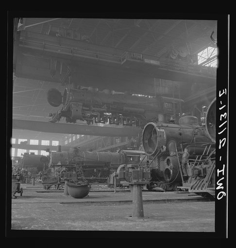 Albuquerque, New Mexico. An engine being carried to another part of the Atchison, Topeka and Santa Fe Railroad shops to be wheeled