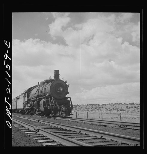 Untitled photo, possibly related to: Acomita, New Mexico. A double-header passenger train passing on the Atchison, Topeka and Santa Fe Railroad between Belen and Gallup, New Mexico