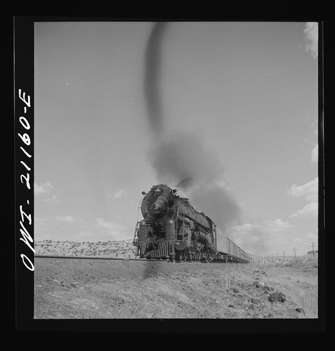 Acomita, New Mexico. A westbound passenger train passing on the Atchison, Topeka and Santa Fe Railroad between Belen and Gallup, New Mexico