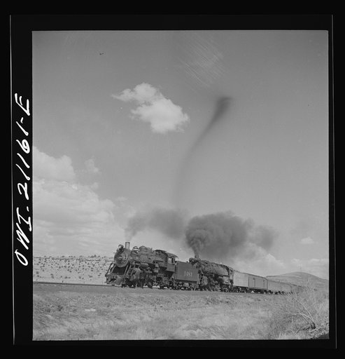 Acomita, New Mexico. A double-header passenger train passing on the Atchison, Topeka and Santa Fe Railroad between Belen and Gallup, New Mexico
