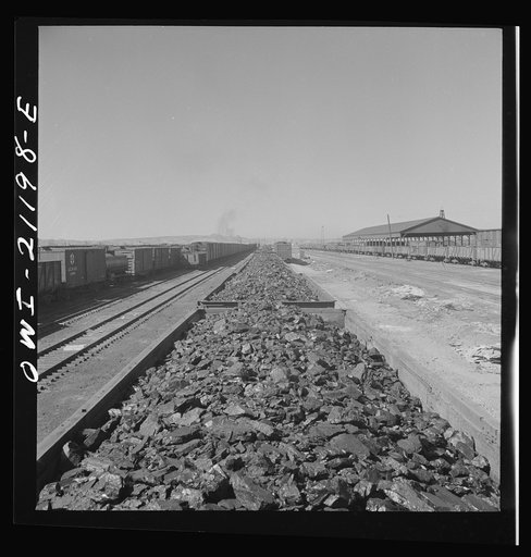 Gallup, New Mexico. Coal from the nearby mines in the Atchison, Topeka and Santa Fe freight yards. The Gallup American Mining Company, operating the coal mines in the vicinity, supplies the railroad with about 150 carloads a week