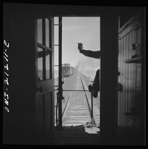 Untitled photo, possibly related to: Havre, Arizona. Passing an eastbound freight train along the Atchison, Topeka and Santa Fe Railroad between Gallup, New Mexico and Winslow, Arizona