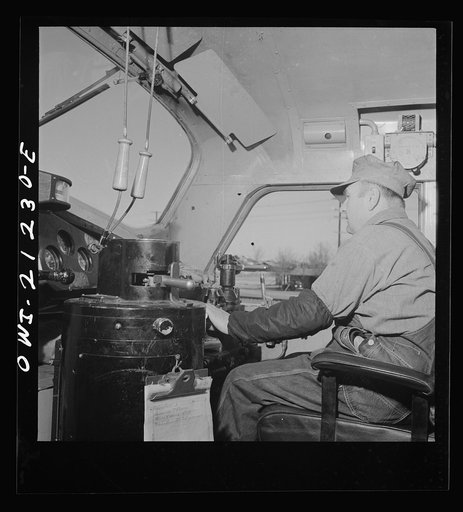 Winslow, Arizona. Engineer George Bertino in the cab of his diesel freight engine, ready to pull out of the Atchison, Topeka and Santa Fe Railroad yard