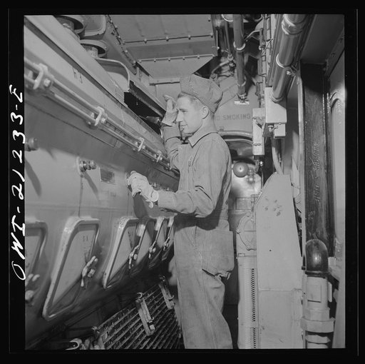 Winslow, Arizona. W.F. Leverenz, maintainer, at work on one of the units of the diesel freight locomotive in the Atchison, Topeka and Santa Fe Railroad yard