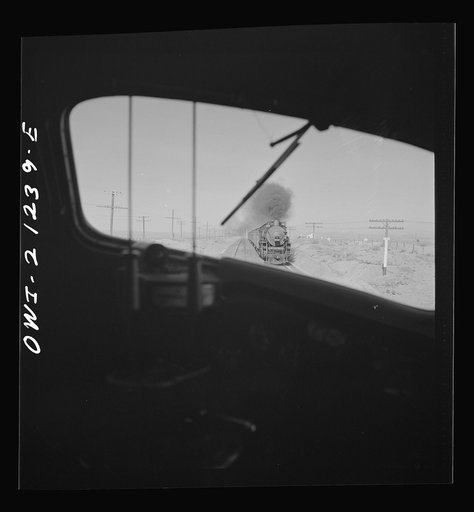Dennison (vicinity), Arizona. On the Atchison, Topeka and Santa Fe Railroad between Winslow and Seligman, Arizona, passing an east-bound passenger train