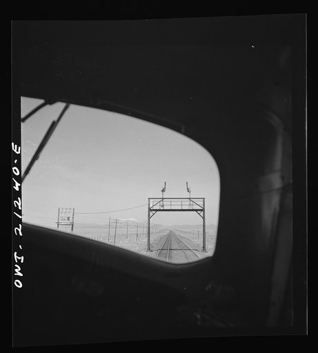 The San Francisco peaks, in the Sierra Nevada range near the California border, seen through the engineer's window of a diesel freight locomotive on the Atchison, Topeka and Santa Fe Railroad between Winslow and Seligman, Arizona