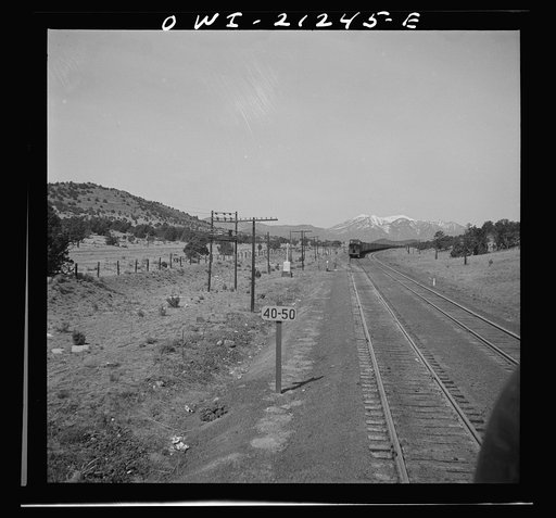 Untitled photo, possibly related to: Winona, Arizona. Passing another freight train in a siding along the Atchison, Topeka and Santa Fe Railroad between Winslow and Seligman, Arizona