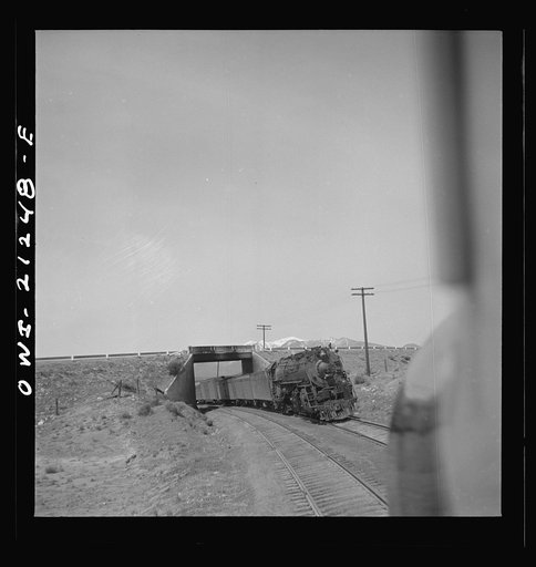 Untitled photo, possibly related to: Winona, Arizona. Passing another freight train in a siding along the Atchison, Topeka and Santa Fe Railroad between Winslow and Seligman, Arizona