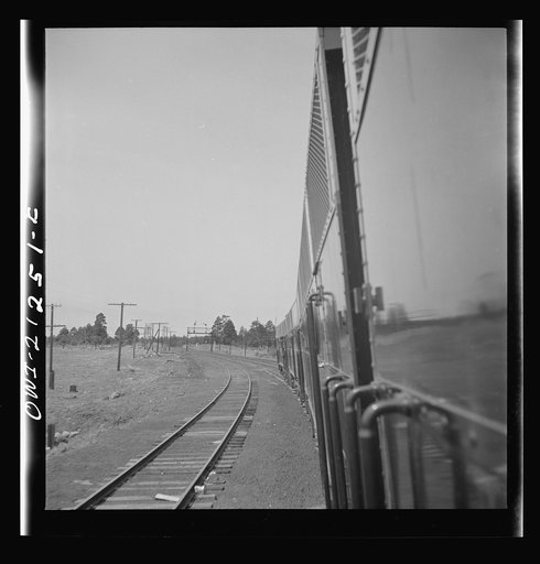 Flagstaff (vicinity), Arizona. Diesel freight train rounding a curve on the Atchison, Topeka, and Santa Fe Railroad between Winslow and Seligman, Arizona