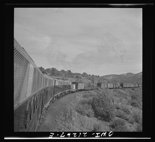 Williams, Arizona. A diesel freight train climbing through mountainous area along the Atchison, Topeka, and Santa Fe Railroad between Winslow and Seligman, Arizona