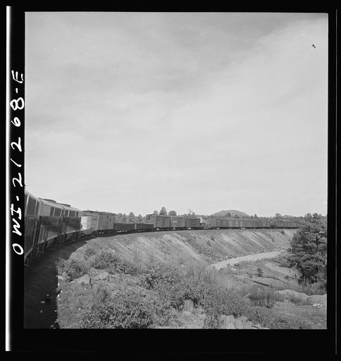 Untitled photo, possibly related to: Williams, Arizona. A diesel freight train climbing through mountainous area along the Atchison, Topeka, and Santa Fe Railroad between Winslow and Seligman, Arizona