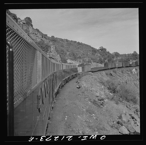Untitled photo, possibly related to: Williams, Arizona. A diesel freight train climbing through mountainous area along the Atchison, Topeka, and Santa Fe Railroad between Winslow and Seligman, Arizona