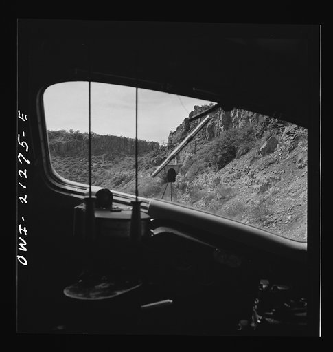Williams (vicinity), Arizona. A train on the Atchison, Topeka, and Santa Fe Railroad between Winslow and Seligman, Arizona about to enter a tunnel through a hillside