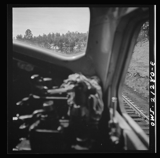 Untitled photo, possibly related to: Williams (vicinity), Arizona. A diesel freight train on the Atchison, Topeka and Santa Fe Railroad between Winslow and Seligman, Arizona going through the mountains