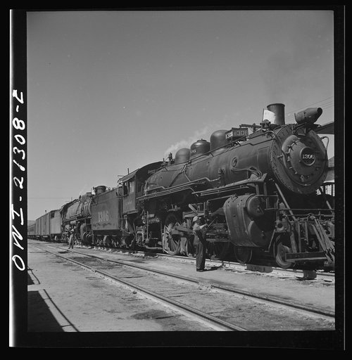 Kingman, Arizona. The engineer of an eastbound train on the Atchison, Topeka and Santa Fe Railroad between Seligman, Arizona and Needles, California, oiling his locomotive