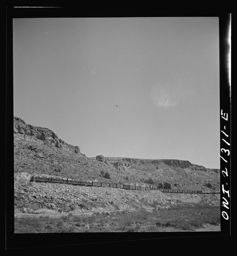 Kingman (vicinity), Arizona. An eastbound diesel freight train on the Atchison, Topeka and Santa Fe Railroad between Seligman, Arizona and Needles, California climbing the mountains