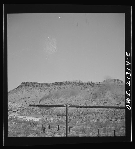 Kingman (vicinity), Arizona. A double-header eastbound passenger train on the Atchison, Topeka and Santa Fe Railroad between Seligman, Arizona and Needles, California, climbing a mountain