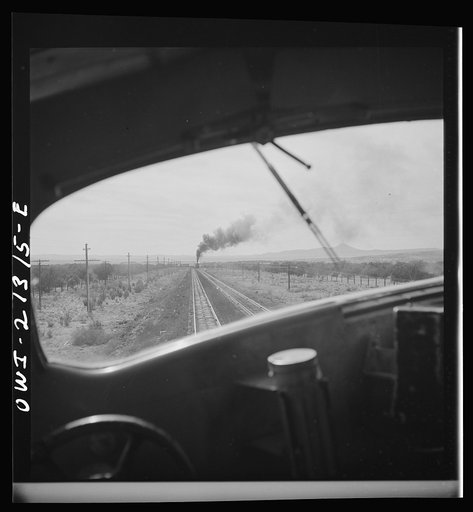 Untitled photo, possibly related to: Ash Fork (vicinity), Arizona. Passing an eastbound freight train on the Atchison, Topeka and Santa Fe Railroad between Winslow and Seligman, Arizona