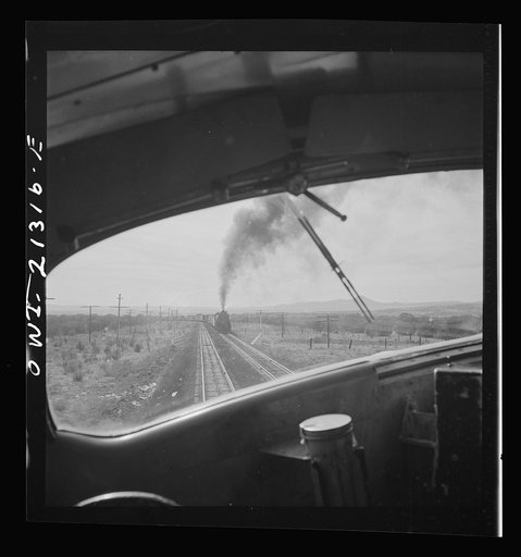 Ash Fork (vicinity), Arizona. Passing an eastbound freight train on the Atchison, Topeka and Santa Fe Railroad between Winslow and Seligman, Arizona