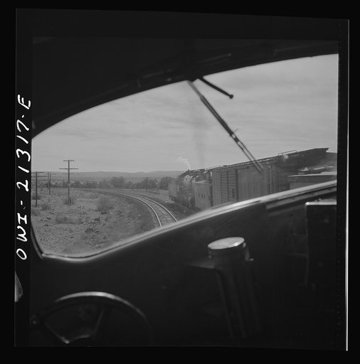 Untitled photo, possibly related to: Ash Fork (vicinity), Arizona. Passing an eastbound freight train on the Atchison, Topeka and Santa Fe Railroad between Winslow and Seligman, Arizona
