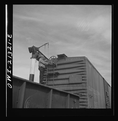 Ash Fork, Arizona. A brakeman closing the retainer on a car in the Atchison, Topeka and Santa Fe Railroad yard
