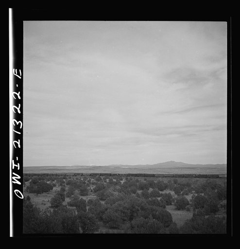 Untitled photo, possibly related to: Gleed (vicinity), Arizona. A freight train going around a curve on the Atchison, Topeka and Santa Fe Railroad between Winslow and Seligman, Arizona