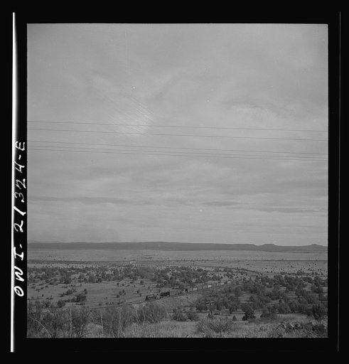 Gleed (vicinity), Arizona. A freight train going around a curve on the Atchison, Topeka and Santa Fe Railroad between Winslow and Seligman, Arizona