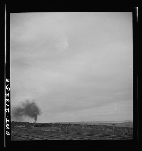 Untitled photo, possibly related to: Gleed (vicinity), Arizona. A freight train going around a curve on the Atchison, Topeka and Santa Fe Railroad between Winslow and Seligman, Arizona