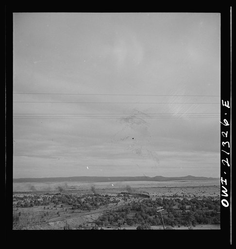 Gleed, Arizona. A westbound passenger train going around a curve on the Atchison, Topeka and Santa Fe Railroad between Winslow and Seligman, Arizona