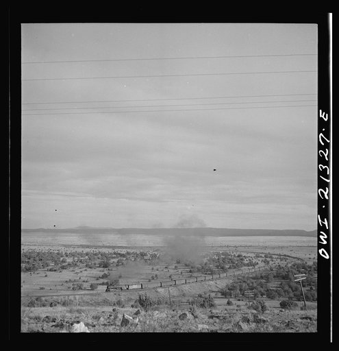 Gleed (vicinity), Arizona. A westbound passenger train going around a curve on the Atchison, Topeka and Santa Fe Railroad between Winslow and Seligman, Arizona
