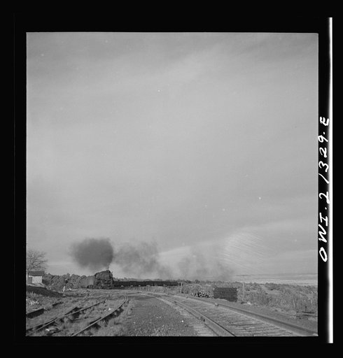 Untitled photo, possibly related to: Gleed (vicinity), Arizona. A freight train going around a curve on the Atchison, Topeka and Santa Fe Railroad between Winslow and Seligman, Arizona