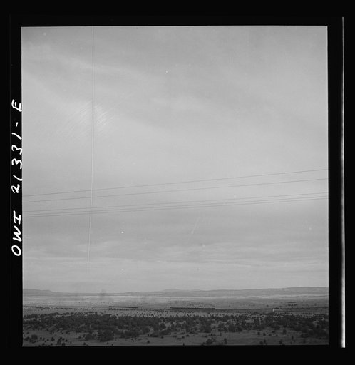 Untitled photo, possibly related to: Gleed (vicinity), Arizona. A freight train going around a curve on the Atchison, Topeka and Santa Fe Railroad between Winslow and Seligman, Arizona