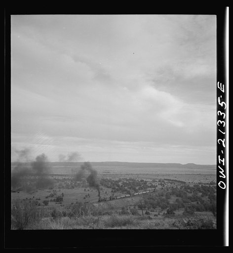 Gleed (vicinity), Arizona. A westbound double-header freight train going around a curve on the Atchison, Topeka, and Santa Fe Railroad between Winslow and Seligman, Arizona