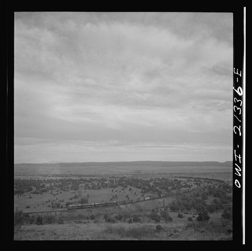 Untitled photo, possibly related to: Gleed (vicinity), Arizona. A westbound double-header freight train going around a curve on the Atchison, Topeka, and Santa Fe Railroad between Winslow and Seligman, Arizona