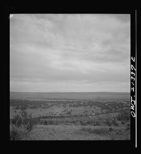 Untitled photo, possibly related to: Gleed (vicinity), Arizona. A westbound double-header freight train going around a curve on the Atchison, Topeka, and Santa Fe Railroad between Winslow and Seligman, Arizona
