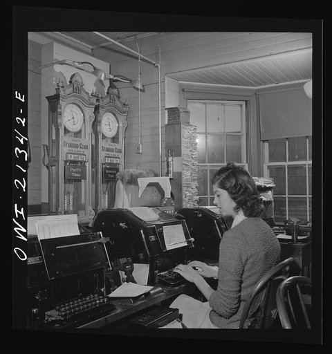 Seligman, Arizona. Teletype operator in the telegraph office of the Atchison, Topeka, and Santa Fe Railroad. The time here changes from Mountain to Pacific time