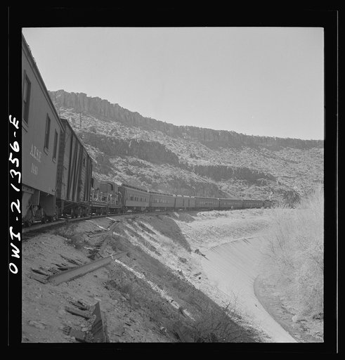 Peach Springs (vicinity), Arizona. A troop train going around a curve on the Atchison, Topeka and Santa Fe Railroad between Seligman, Arizona and Needles, California